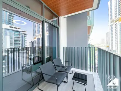 a balcony with chairs and a view of the city at Luxury Studio in Meydan With Gym, Pool Access in Dubai