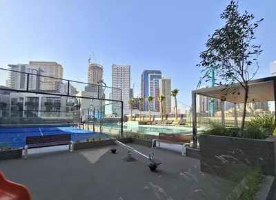 a swimming pool in a city with tall buildings at Chic 2BR Flat in Park Lane Dubai in Dubai