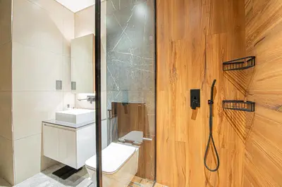a bathroom with a shower and a toilet and a sink at Chic 2BR Flat in Park Lane Dubai in Dubai