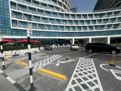 a parking lot in front of a large building at FullSeaView-RoofTopPool Free Private WestBeachAccess in Dubai