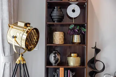 a book shelf with various items on it at Fabulous 2 BR - Paramount Midtown in Dubai