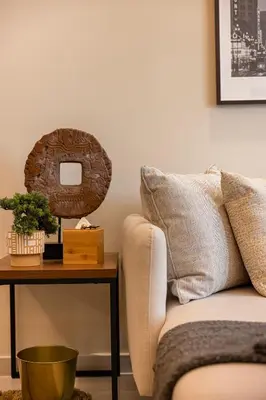 a living room with a couch and a table with a mirror at Fabulous 2 BR - Paramount Midtown in Dubai