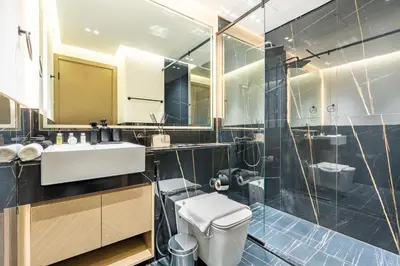 a bathroom with a toilet and a sink and a shower at Canal and Burj Khalifa Views, Few Minutes Drive to Downtown Dubai and 15 Minutes Drive to Kite Beach, Binghatti Canal, Business Bay by Deluxe Holiday Homes in Dubai