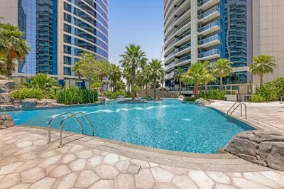a swimming pool in a city with tall buildings at 2BR Midtown Gem - Luxurious Apartment with Balcony in Dubai
