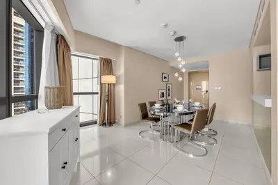 a kitchen and dining room with a table and chairs at 2BR Midtown Gem - Luxurious Apartment with Balcony in Dubai