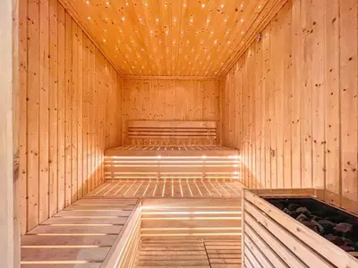 a wooden sauna with a bench in the middle at KeyRock - Modern 1BR in Zada with Pool & View in Dubai