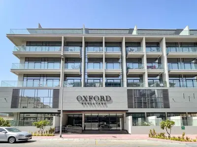 an office building with a sign for the oxford hotel at HAVN - Brand New Studio in Oxford Boulevard, JVC in Dubai