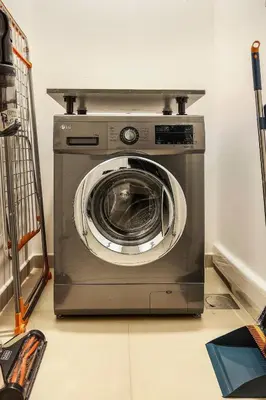 a washing machine sitting on top of a room at FIRST CLASS 1BR Modern Comfort in the City in Dubai