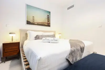 a bedroom with a large white bed and a bridge at FIRST CLASS 1BR Modern Comfort in the City in Dubai