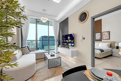 a living room with a couch and a table at Tranquil 1BR Prime Arjan in Dubai