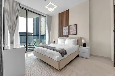 a bedroom with a large bed and a large window at Tranquil 1BR Prime Arjan in Dubai