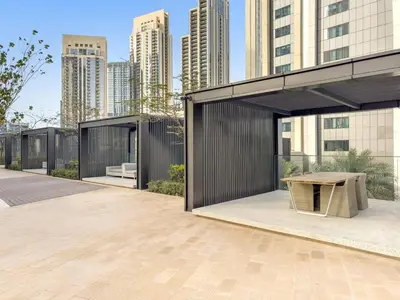 a pavilion with a bench in front of a building at Luxury 2BR Dubai Creek Harbour with Pool, Gym, Parking & Balcony Views in Dubai