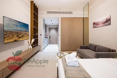 a living room with a couch and a table at Beautiful Brand New Studio in Dubai