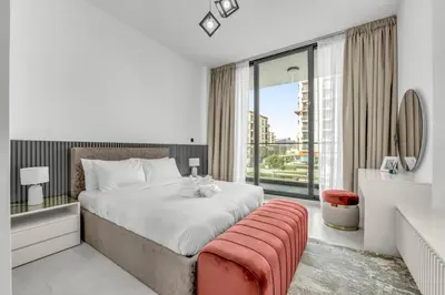 a bedroom with a large bed and a large window at Brand New Luxury 2 Bedroom in Dubai