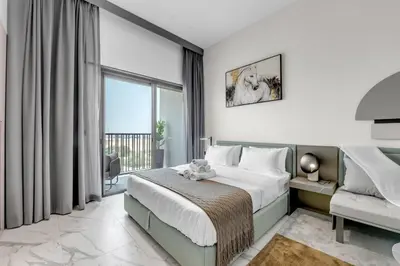 a bedroom with a bed and a large window at New Studio in Meydan I MAG 890 in Dubai