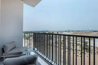a living room with a balcony with a view of the beach at New Studio in Meydan I MAG 890 in Dubai