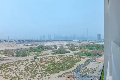 an aerial view of a desert with buildings in the background at New Studio in Meydan I MAG 890 in Dubai