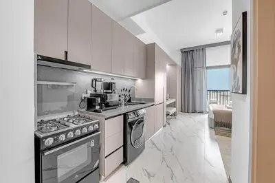 a kitchen with a stove and a sink at New Studio in Meydan I MAG 890 in Dubai