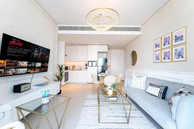 a living room with a couch and a table at Luxury 1BR Sea View Apt Address JBR Dubai in Dubai