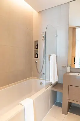 a bathroom with a tub and a sink at Luxury 1BR Sea View Apt Address JBR Dubai in Dubai