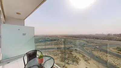 a glass balcony with a table and a view of a city at Carson A - High Rise Cosy Studio with City Views in Dubai