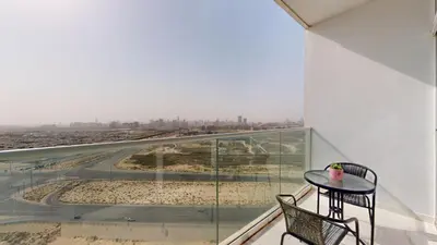 a balcony with a table and chairs and a view at Carson A - High Rise Cosy Studio with City Views in Dubai