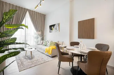 a living room with a table and a couch at Luxury Stay in JVC in Dubai