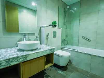 a bathroom with a sink and a toilet and a shower at Modern 2BR Apartment with Stunning City Views in Dubai