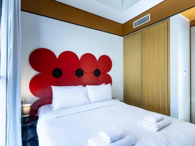 a bedroom with a red headboard and a white bed at Modern 2BR Apartment with Stunning City Views in Dubai
