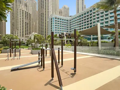 a playground in a city with tall buildings at Sea View 2BR Apartment With Private Beach in Dubai