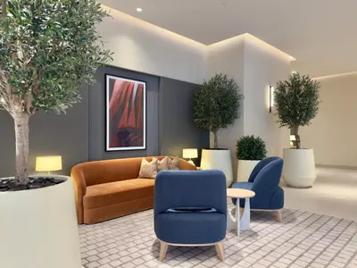 a lobby with a couch and chairs and trees at Vida Dubai Mall Connected 2BR in Sabkhah