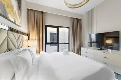 a white bedroom with a large bed and a large window at FIRST CLASS Villa Private Pool & Garden Bliss in Dubai