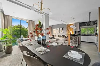 a dining room and living room with a table and chairs at FIRST CLASS Villa Private Pool & Garden Bliss in Dubai
