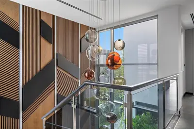 a glass staircase with glass balls on the wall at FIRST CLASS Villa Private Pool & Garden Bliss in Dubai