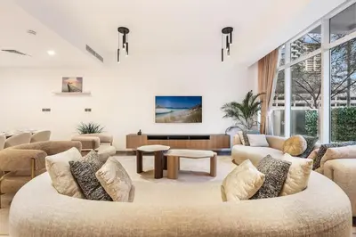 a living room with a couch and a table at FIRST CLASS VILLA Tranquility Meets Luxury in Dubai