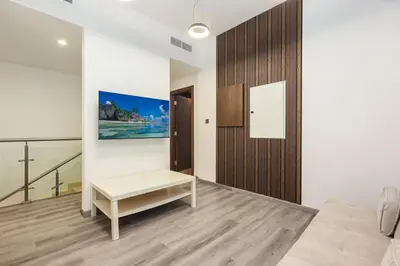 a living room with a couch and a table at FIRST CLASS VILLA Tranquility Meets Luxury in Dubai