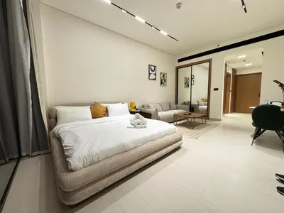 a bedroom with a bed and a living room at DVR Studio Apartment with private jaccuzi in Trillionaire by Binghatti Business Bay in Dubai