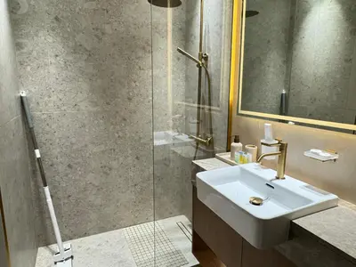 a bathroom with a sink and a shower at DVR Studio Apartment with private jaccuzi in Trillionaire by Binghatti Business Bay in Dubai