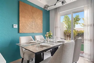 a dining room with a table and chairs at FIRST CLASS VILLA Spacious for Family Getaways in Dubai