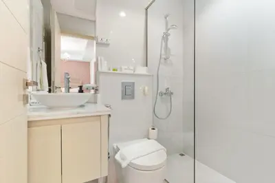 a bathroom with a toilet and a sink and a shower at FIRST CLASS VILLA Spacious for Family Getaways in Dubai