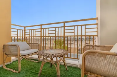 a balcony with a table and chairs and a view at FIRST CLASS VILLA Spacious for Family Getaways in Dubai