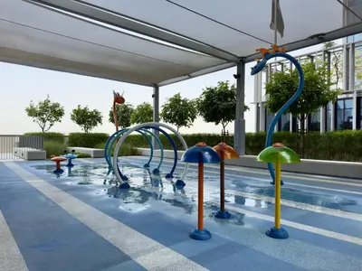 a pool with some water slides in a swimming pool at Vida Dubai Mall Connected 1BR in Dubai