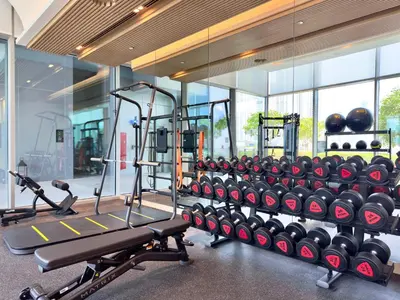 a gym with a row of treadmills and weights at Vida Dubai Mall Connected 1BR in Dubai