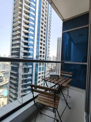 a balcony with a table and a chair on a building at Bay View in Marina Bay in Dubai