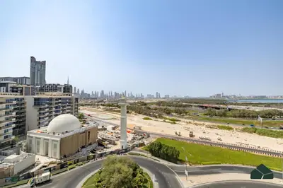 a view of a city with a road and a beach at Stylish 1BR with City and Partial Burj View by BMS in Dubai