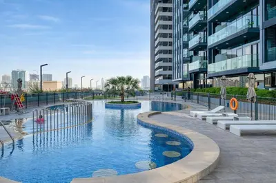 a swimming pool in a city with buildings at Resort lifestyle, Fantastic Views, Bright & Brand new in Dubai
