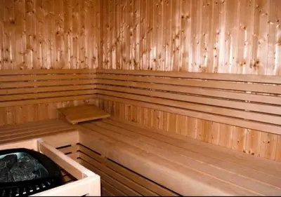 an empty sauna with wooden paneled walls at Resort lifestyle, Fantastic Views, Bright & Brand new in Dubai