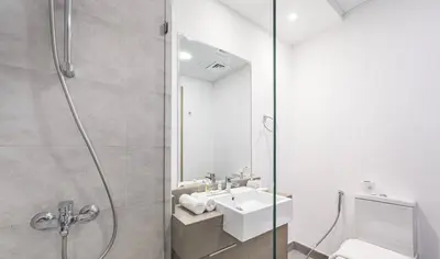 a white bathroom with a sink and a shower at Resort lifestyle, Fantastic Views, Bright & Brand new in Dubai