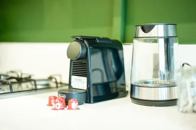 a coffee maker sitting on a counter next to a blender at Damac Maison Canal Views, Luxury Waterfront Apartment, 2 BR, Dedicated Office, Sleeps 6 in Dubai