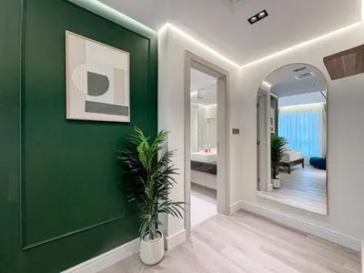 a bathroom with a green wall with a potted plant at Damac Maison Canal Views, Luxury Waterfront Apartment, 2 BR, Dedicated Office, Sleeps 6 in Dubai